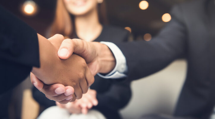 Businessmen shaking hands after meeting in a cafe